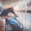 man waiting for train with backpack