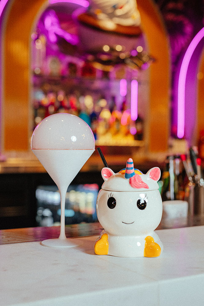 Two cocktails at Hijinx Hotel, one with a bubble on top and one in a unicorn cup