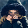 Winter skincare peels: woman in fur hooded coat covering half her face