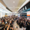 Crowd cheers and confetti bursts into the sky in front of Sephora store