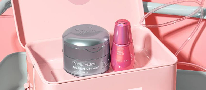 A blue and a pink Dr Naomi Skin product sit side by side in a pink box.