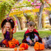 Children in spooky costumes sitting on South Bank lawn