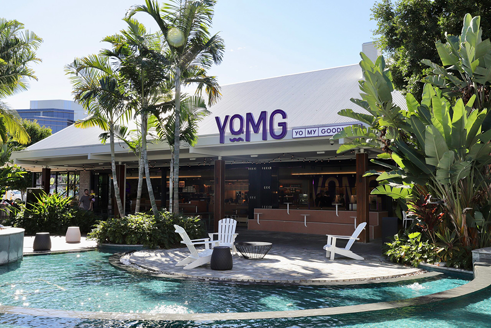 Exterior of YOMG Brisbane, with a water feature out the front.