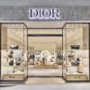 Exterior of a Dior store, with floor to ceiling windows and grey marble surrounds