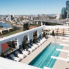 An aerial view of the Hotel X rooftop pool with a view of the Story Bridge and cityscape in the background